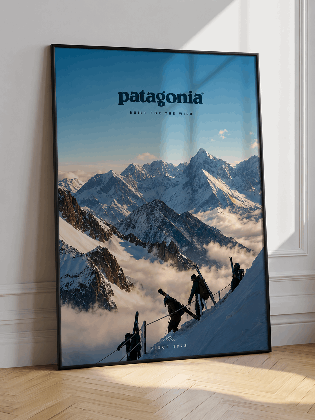 Framed blue alpine ski wall art with mountain peaks, skiers, and patagonia logo