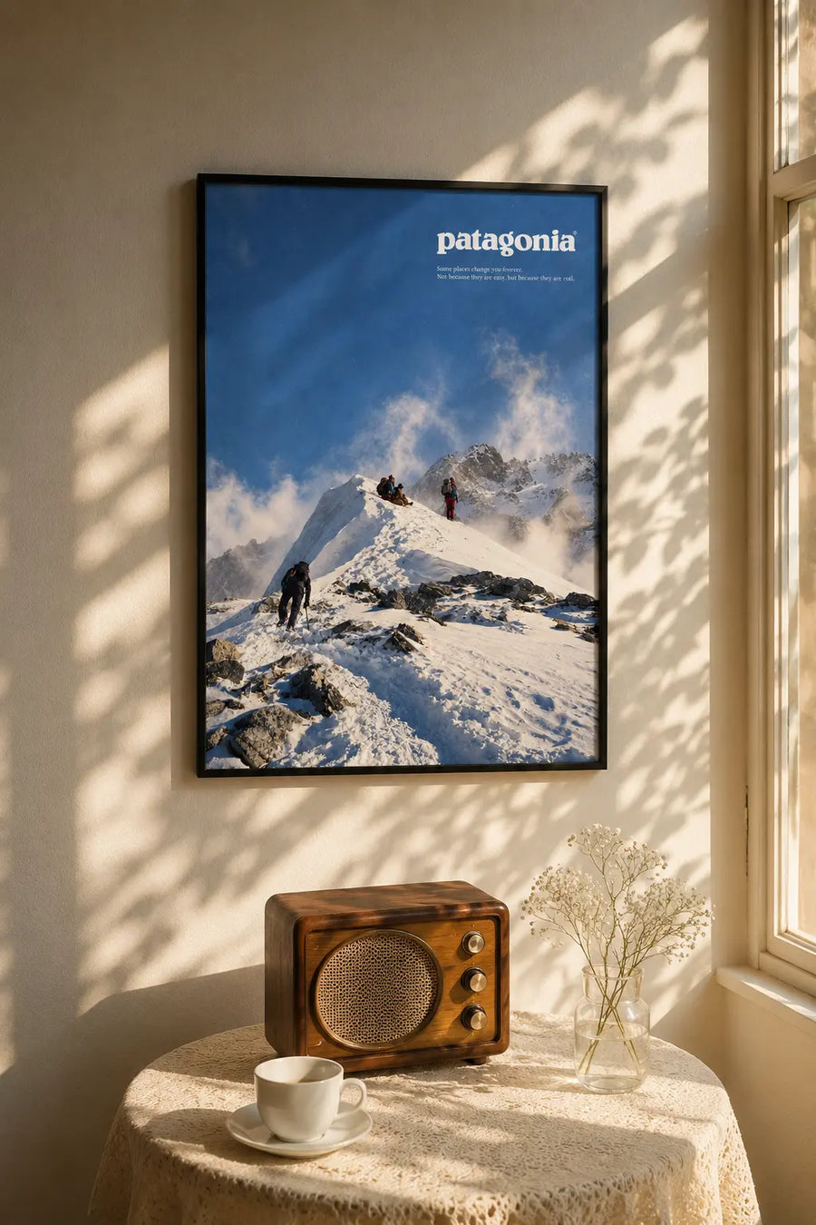 Framed Snow Peak wall art print with hikers on snowy mountainscape, Patagonia logo