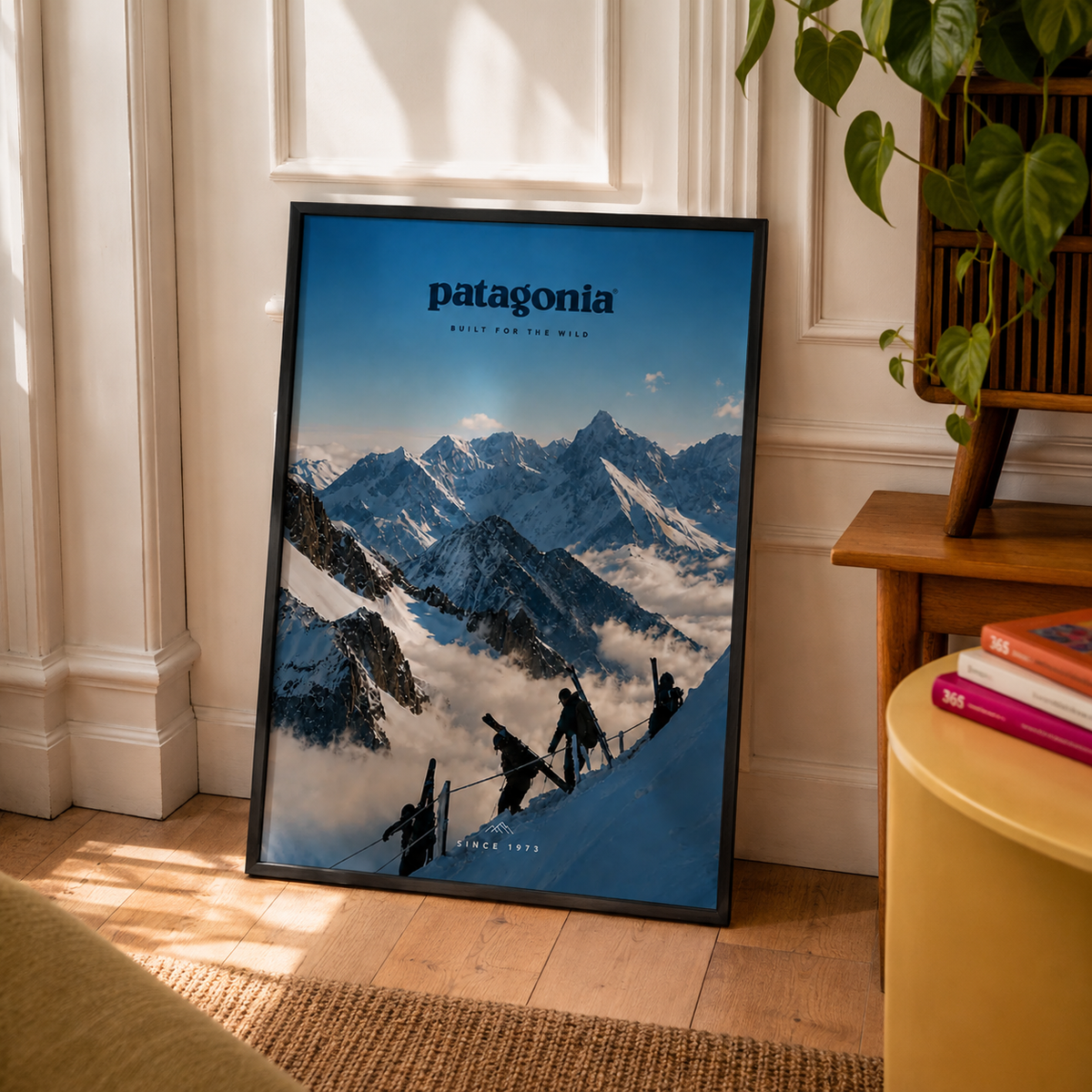 Patagonia Mountain Artwork displayed in a black frame with living room details 