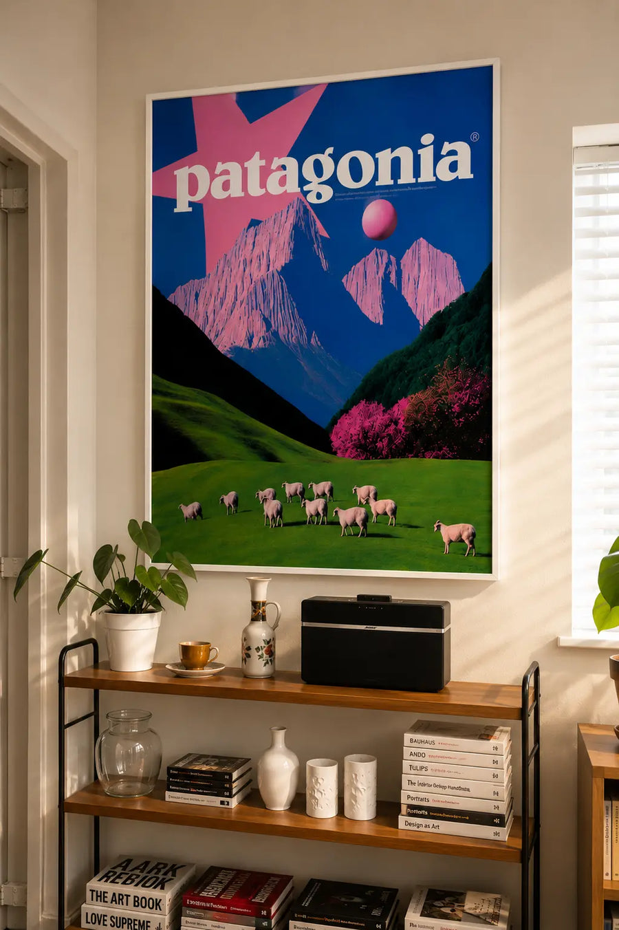 Framed Patagonia wall art poster featuring mountains, pink sky, and sheep in green field