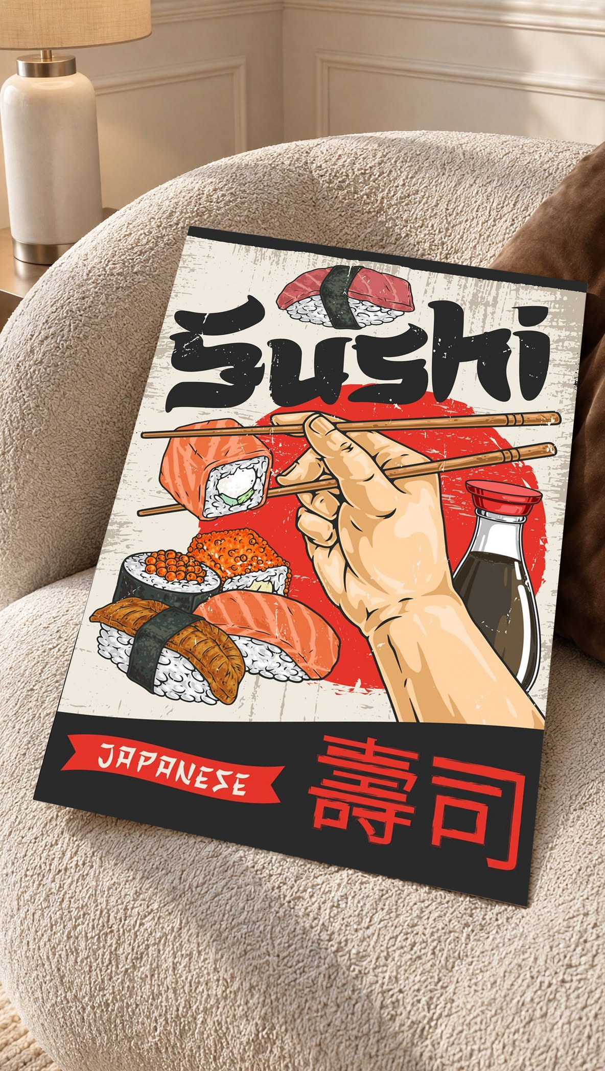 Black-framed sushi wall art print on cushioned chair with chopsticks, sushi rolls, Japanese text
