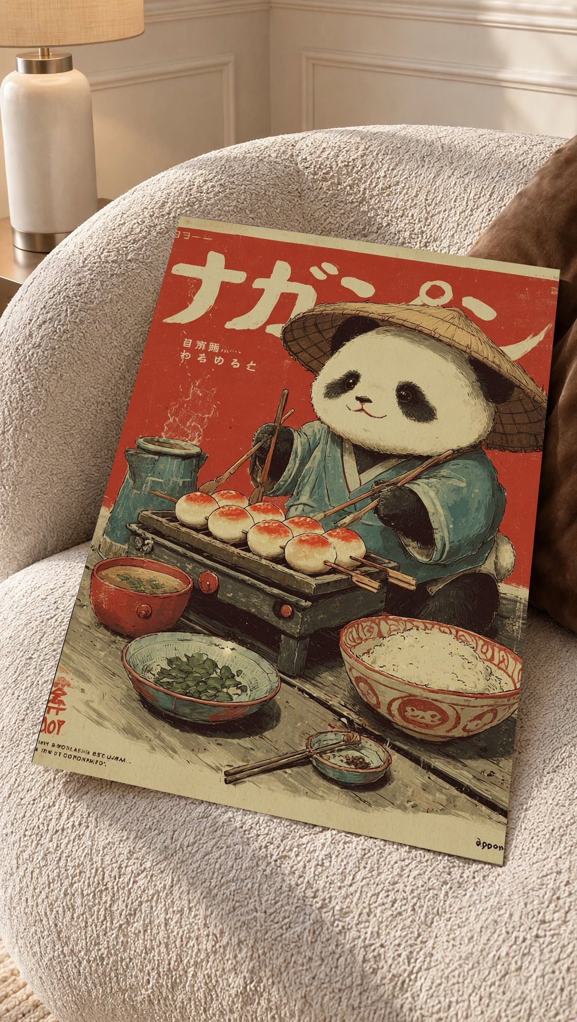 Panda art print poster leaning on sofa, panda chef in hat with dishes and bowls