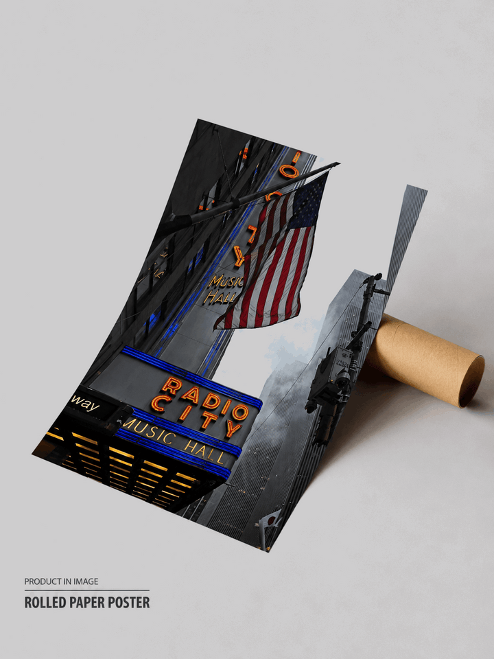 Rolled black travel poster with Radio City and US flag street scene