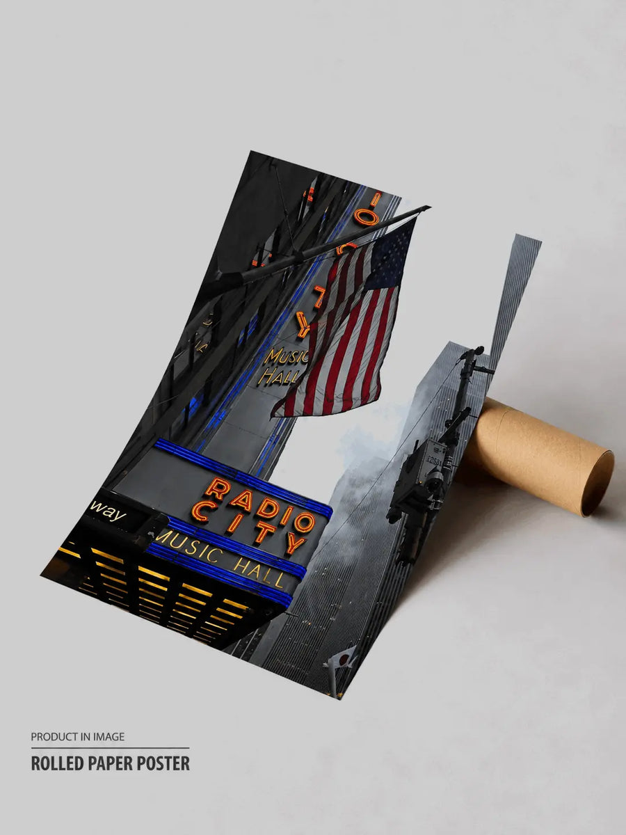Rolled black travel poster with Radio City and US flag street scene