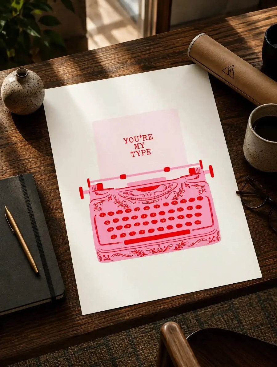 Typewriter print on white paper with red typewriter illustration and quote on wooden desk