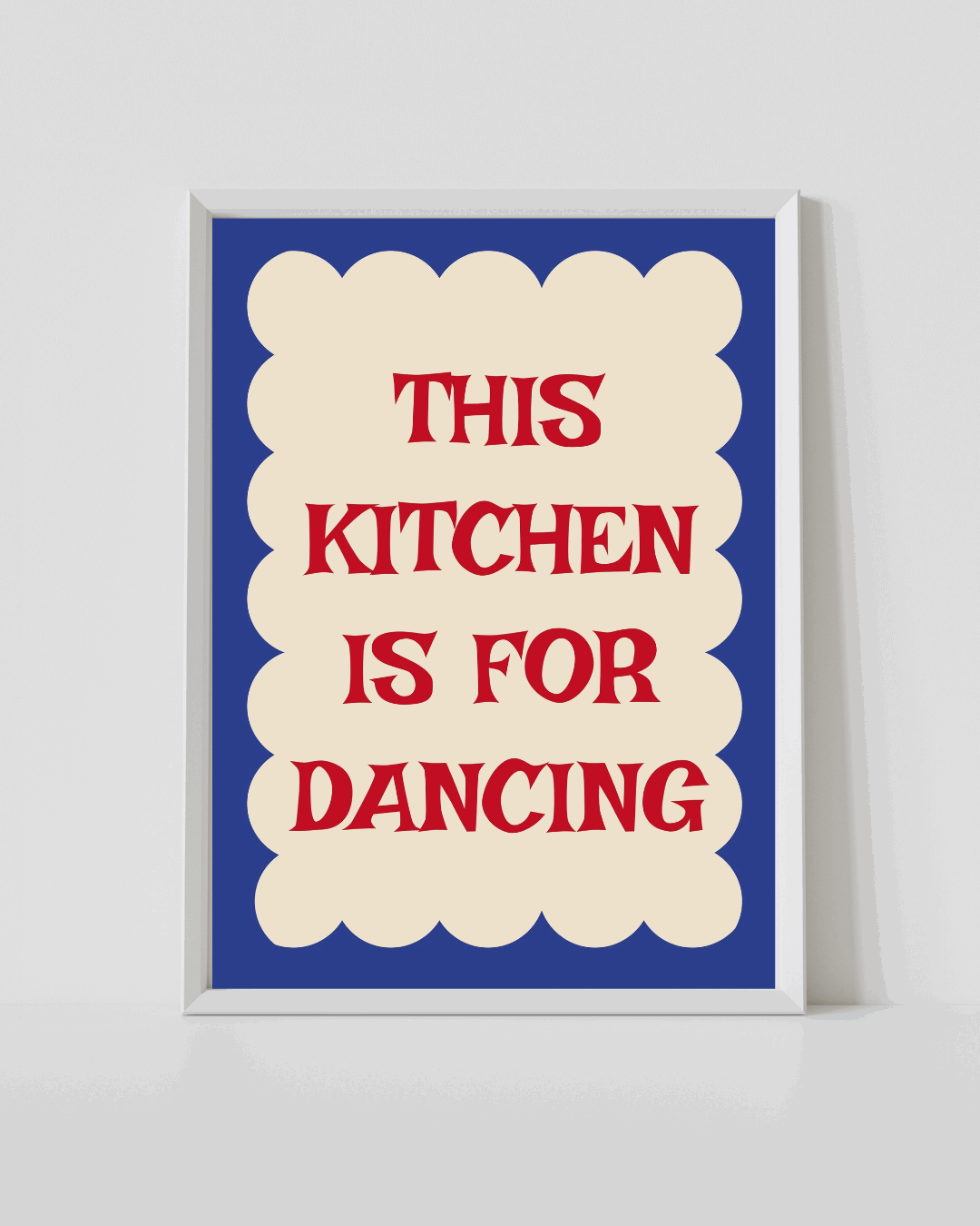 Framed kitchen quote print, white frame, blue background with red “THIS KITCHEN IS FOR DANCING”.