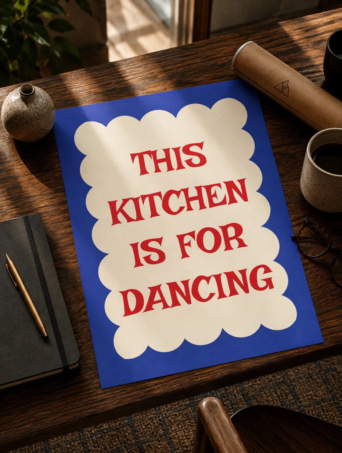 Kitchen quote print on blue sheet with cream scalloped border and red “THIS KITCHEN IS FOR DANCING”.