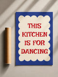 Kitchen quote print, blue poster with cream scalloped border and red “THIS KITCHEN IS FOR DANCING”.