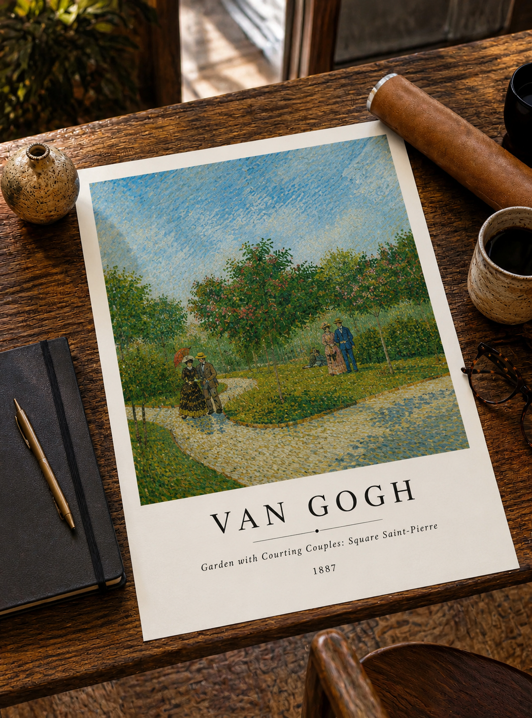 Landscape print on desk, garden scene with blue sky, green trees, two people walking
