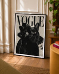 Framed black cat portrait art print standing on floor, “VOGUE” text at top.