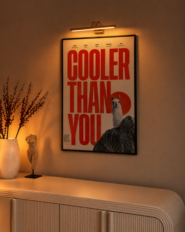 Gold picture light displayed above wall art in a contemporary living room interior.