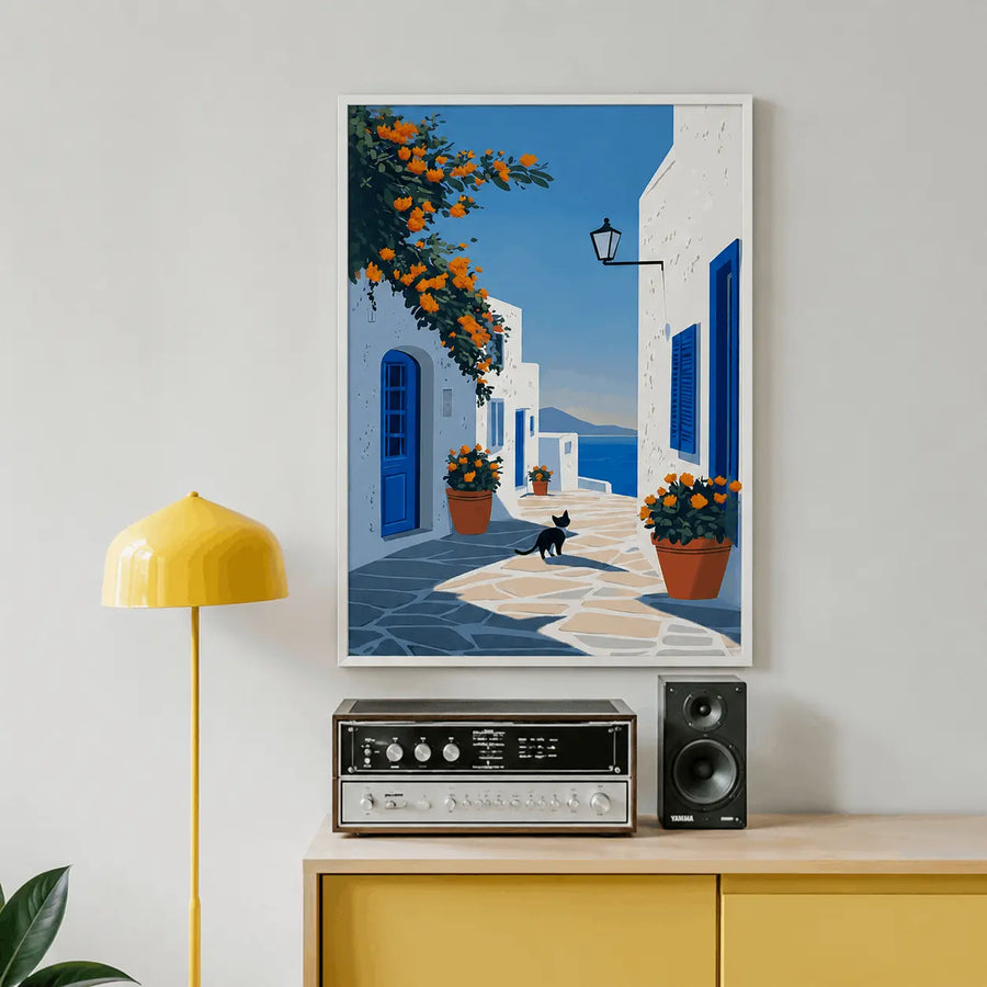 Framed wall print with blue alley, orange flowers in pots, and black cat