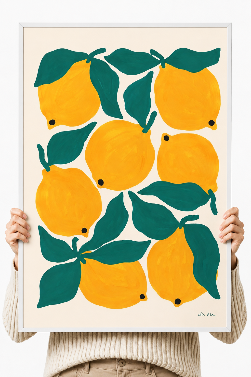 Lemon and green leaf art print on white paper held by two hands