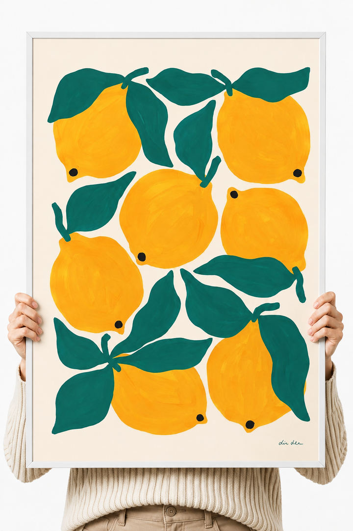 Lemon and green leaf art print on white paper held by two hands