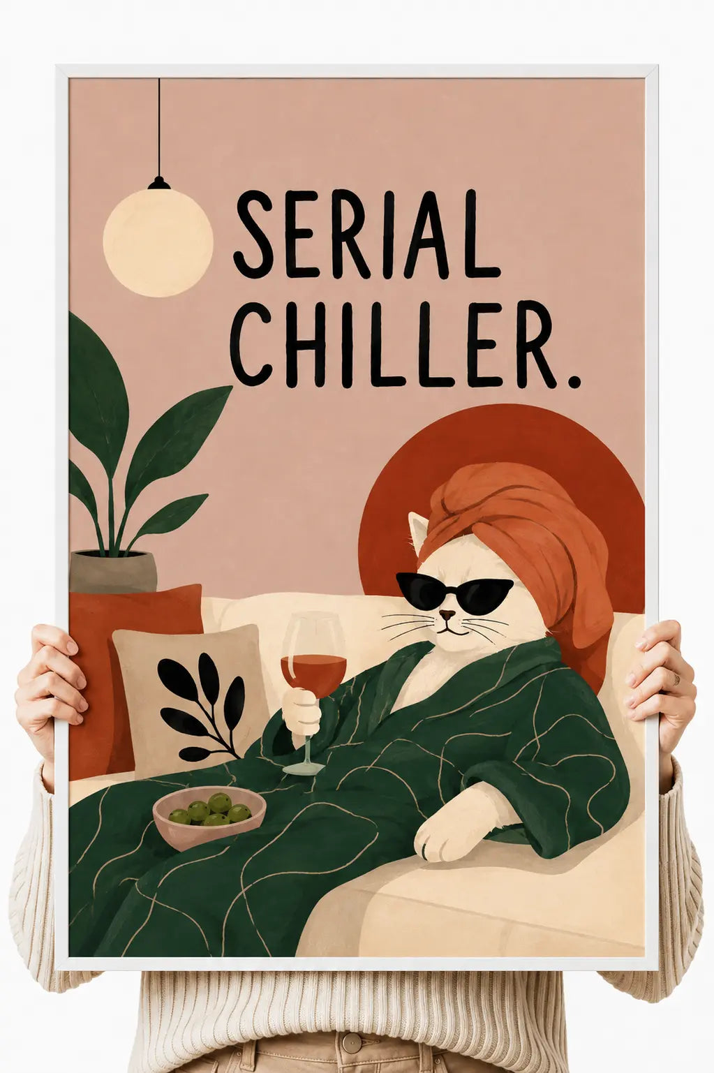 Cat art print with light frame held up by hands, orange cat with sunglasses, “Serial Chiller”