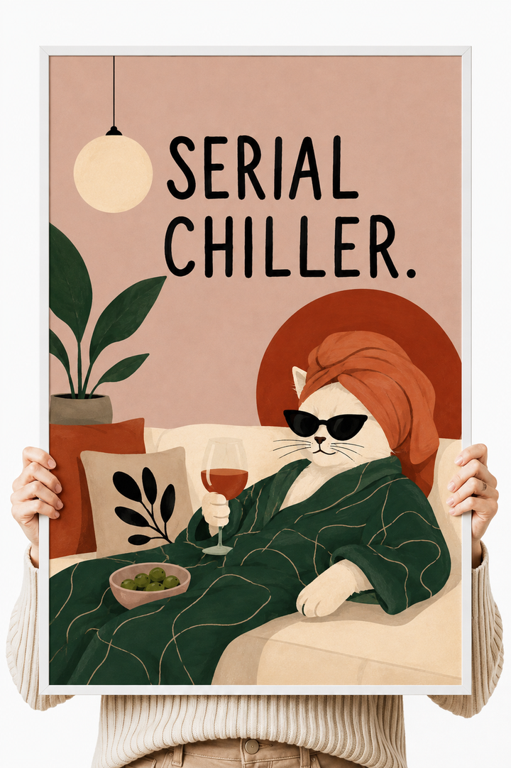 Cat art print with light frame held up by hands, orange cat with sunglasses, “Serial Chiller”