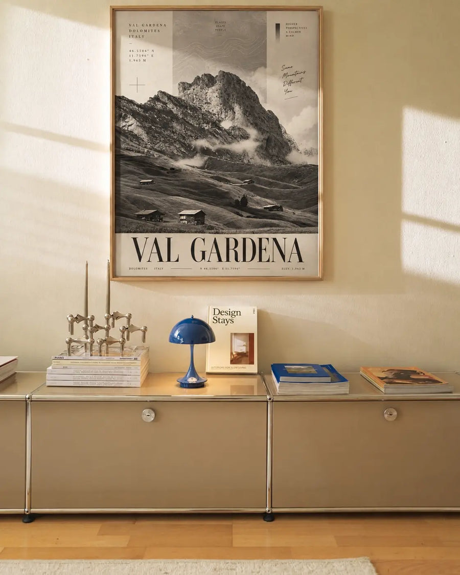 Val Gardena Mountain Poster displayed in a bright modern interior with monochrome Italian mountain scenery and bold typography