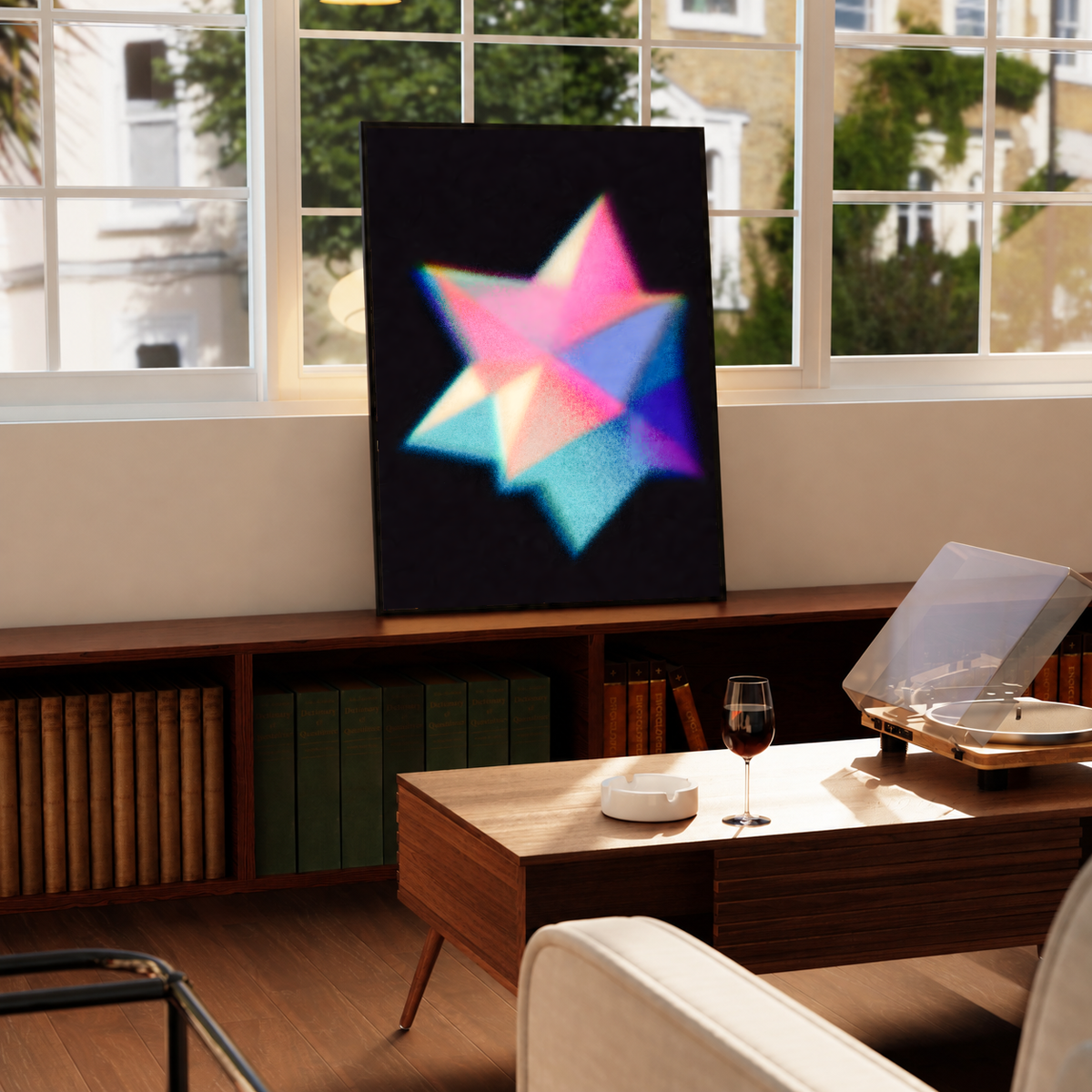 Overlapping pink cyan blue and purple geometric star shapes with grain and soft glow on black, styled in a black frame above a wood console with books and a record player