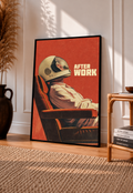 An astronaut reclining in an armchair against a burnt-orange ground in a black frame leaning on a sunlit floor beside a rattan chair