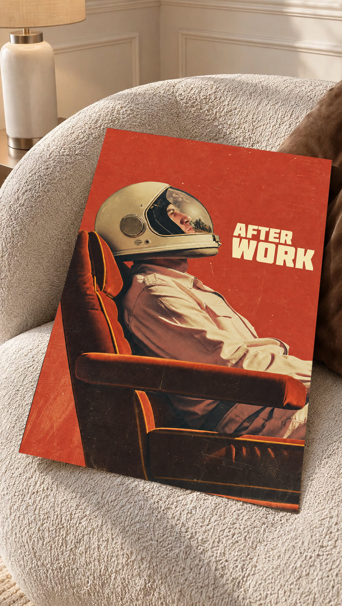An astronaut reclining in an armchair against a burnt-orange ground as an unframed poster resting on a cream woven chair