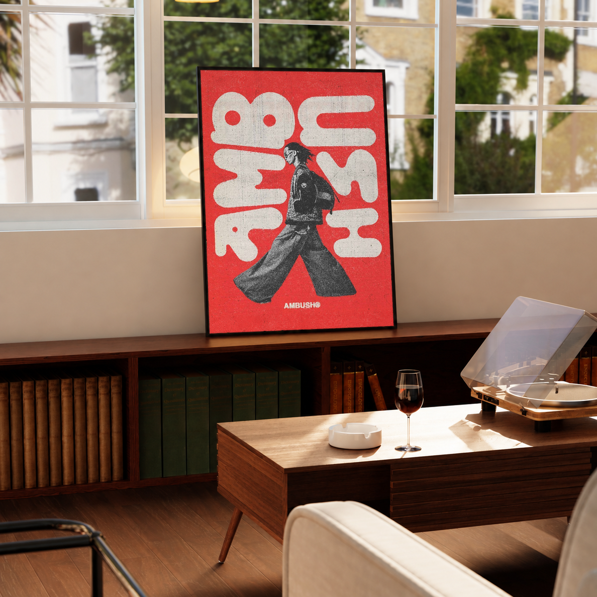 Black-framed red poster with white abstract letters and black walking figure; AMBUSH