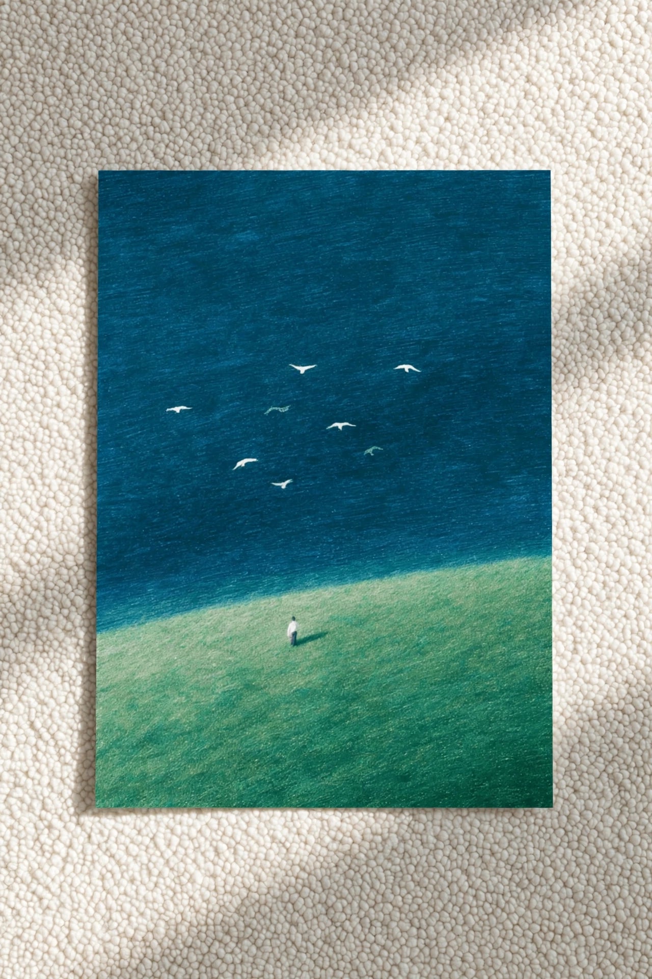 Blue ocean and birds wall art print with small figure standing on green shore
