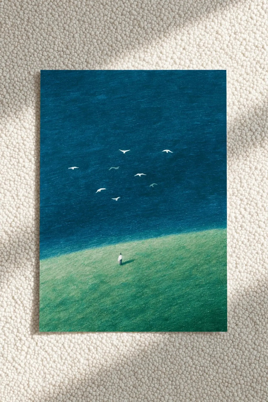 Blue ocean and birds wall art print with small figure standing on green shore