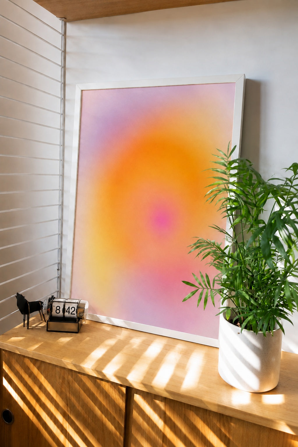 Framed abstract gradient wall art in pastel orange, pink, and purple