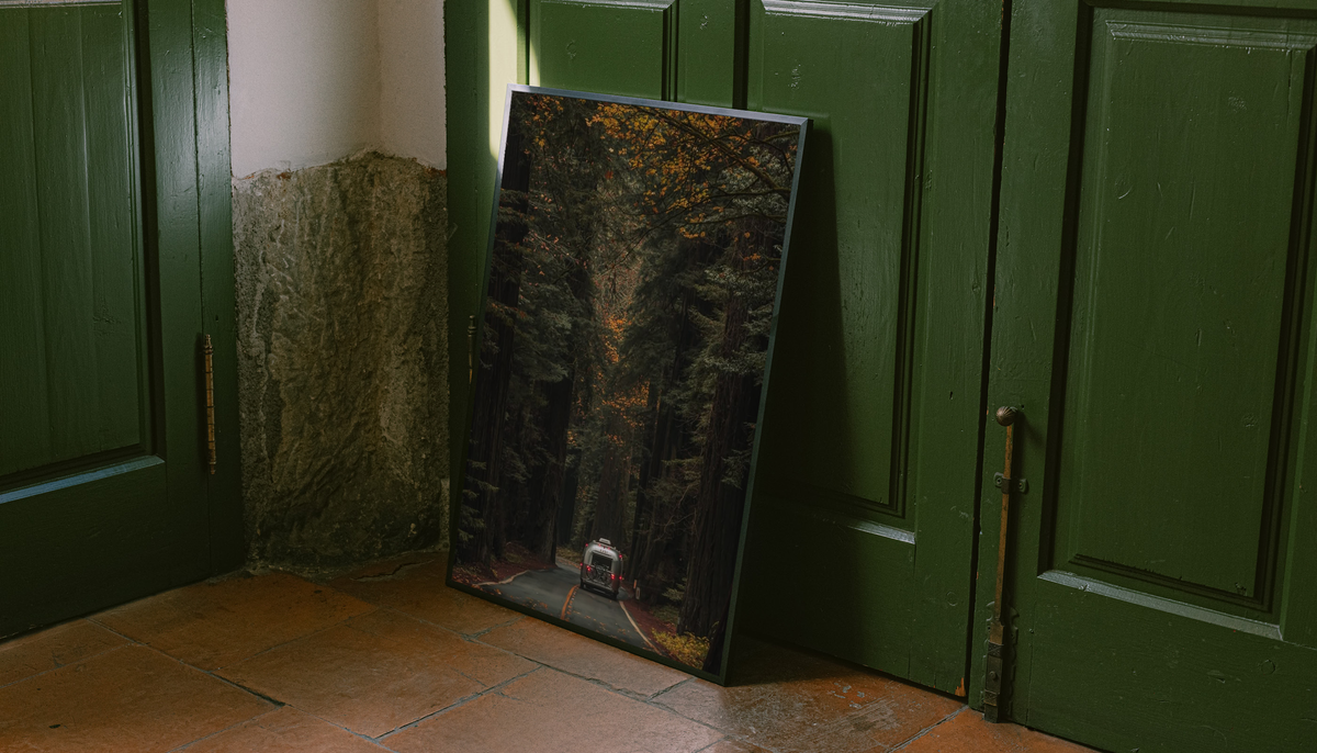 Autumn Forest Road Poster shown as a canvas leaning beside green panels on a wooden floor.