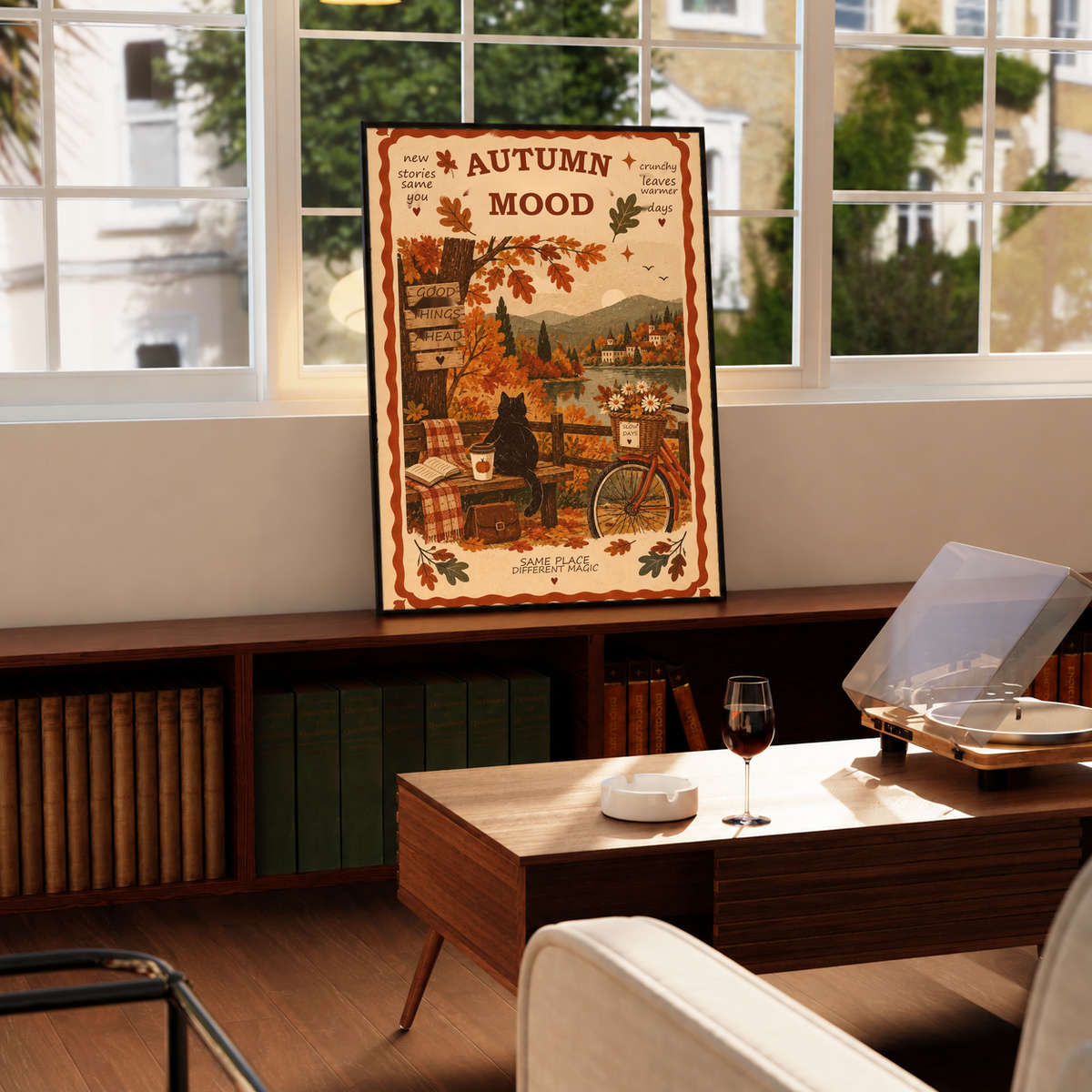 Framed autumn mood poster on wooden surface, black cat and bicycle scene