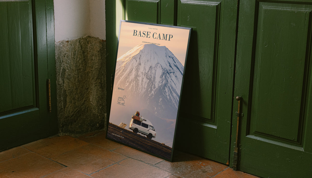 Base Camp camper van poster leaning against a green door