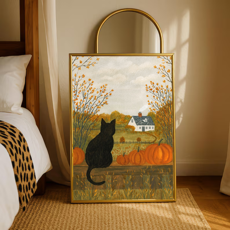 Autumn farmhouse art print with a black cat, pumpkins, and golden trees in a gold frame.
