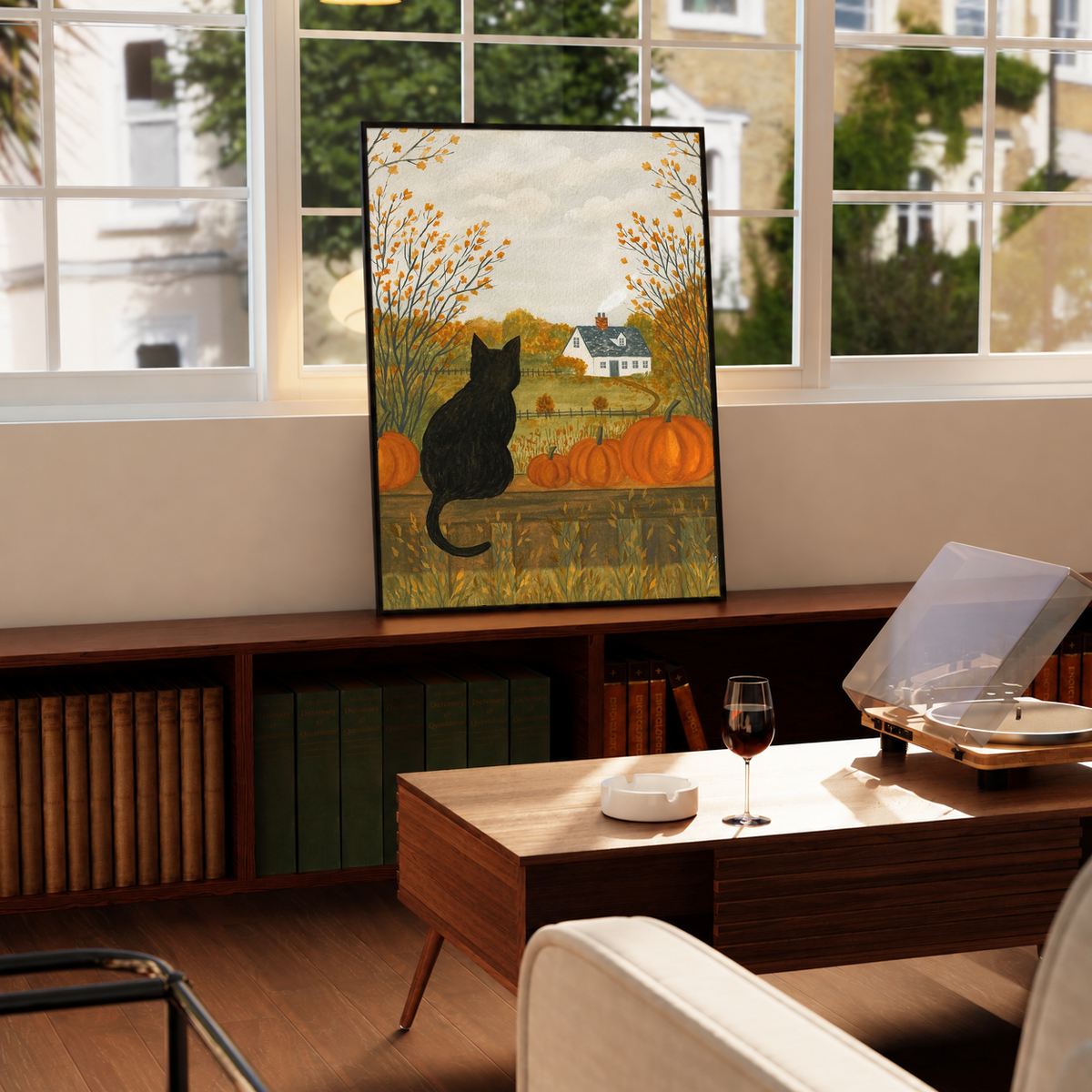Autumn farmhouse art print of a black cat with pumpkins and golden trees, framed and standing.