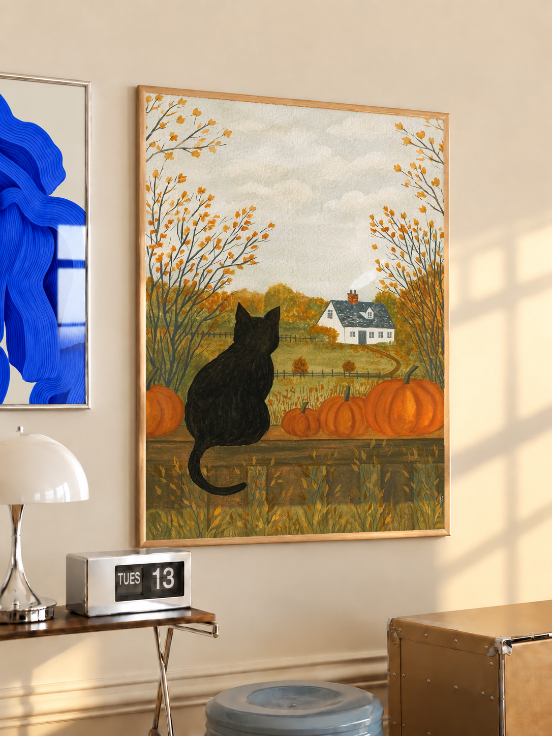 Autumn farmhouse art print of a black cat in a light wood frame with pumpkins and trees.
