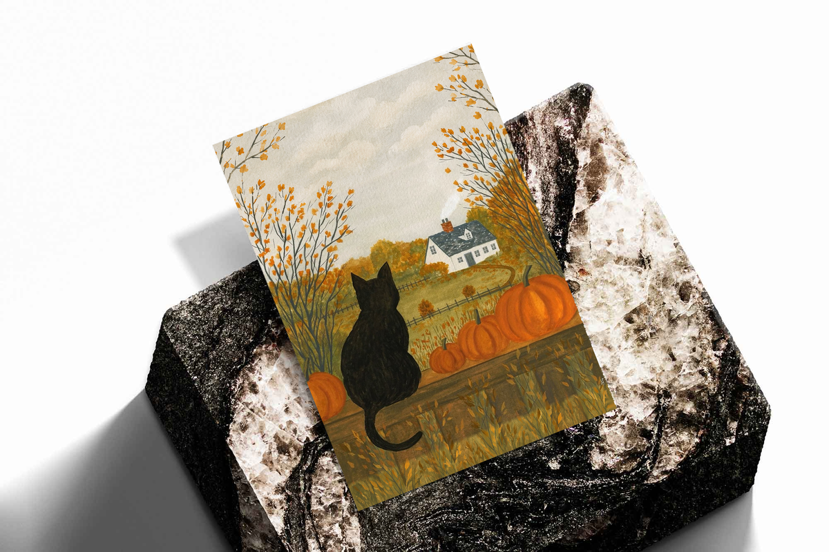 Folded autumn farmhouse art prints showing a black cat with pumpkins and golden trees.