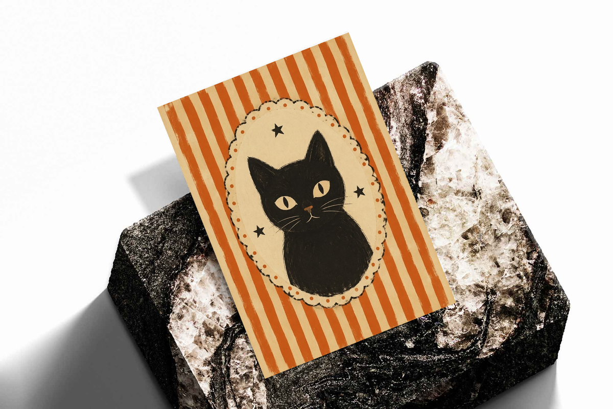 Cat cameo poster with orange stripes and black cat in cream scalloped oval, resting on rocks