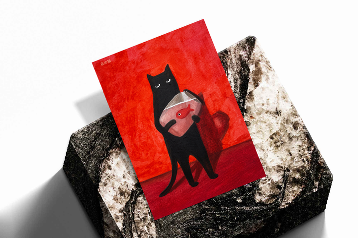 Black cat holding a fishbowl as an unframed print propped against a pale wall on a rough stone