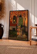 Black-framed Halloween art print with green door, lanterns, and jack-o'-lanterns
