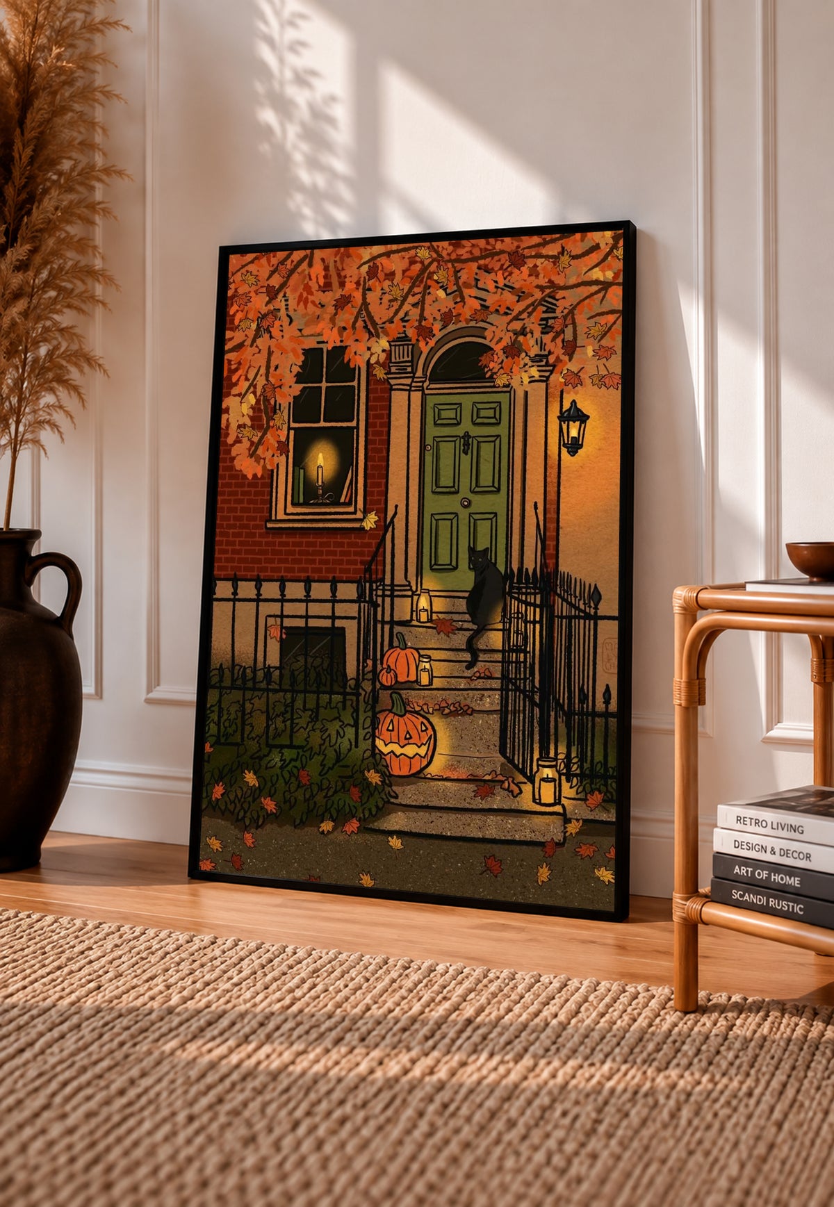 Black cat on townhouse steps beside a green door orange ivy and jack o lanterns in a black frame leaning on a sunlit wooden floor beside books and a rattan seat