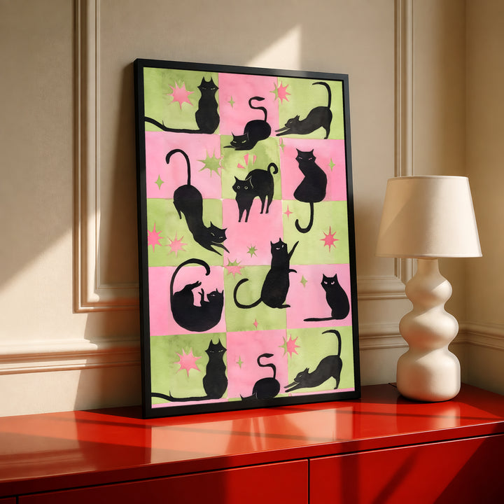 Black-framed cat silhouette wall art with pink-and-green checkerboard and star accents
