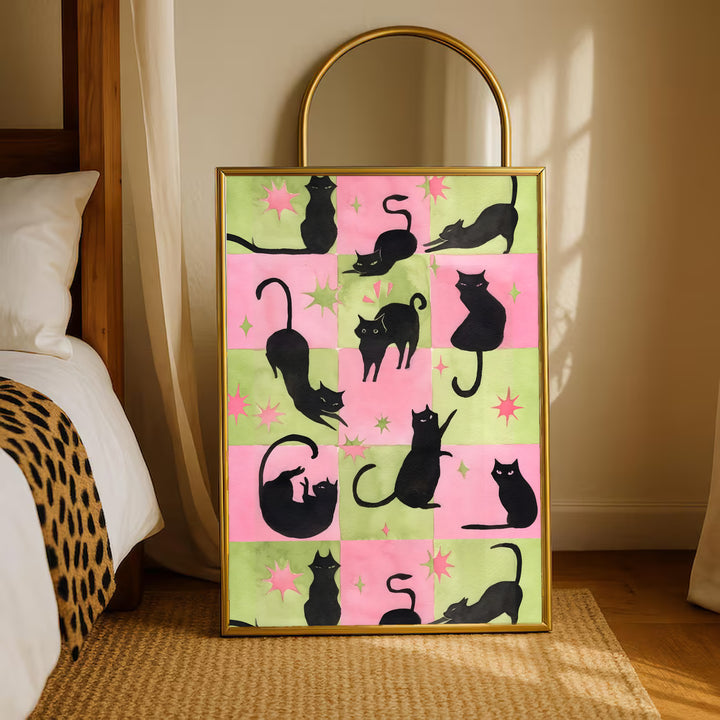 Gold-framed cat silhouette print with pink-and-green checkerboard blocks and stars