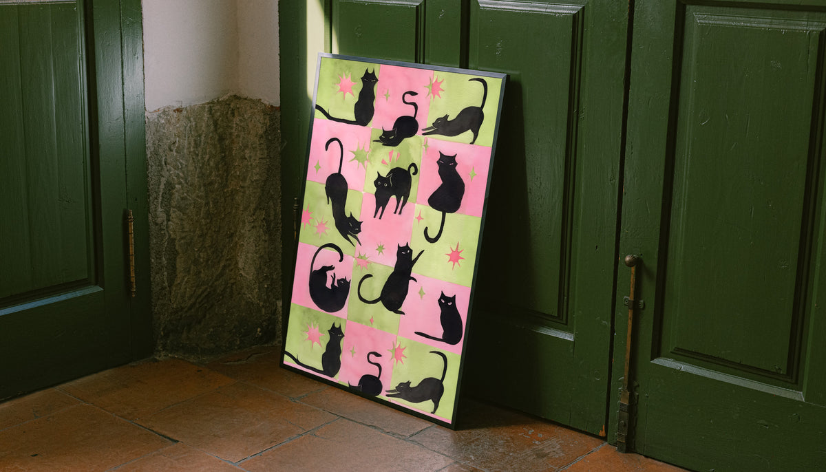 Framed cat silhouette artwork with pink-green checkerboard pattern and star motifs