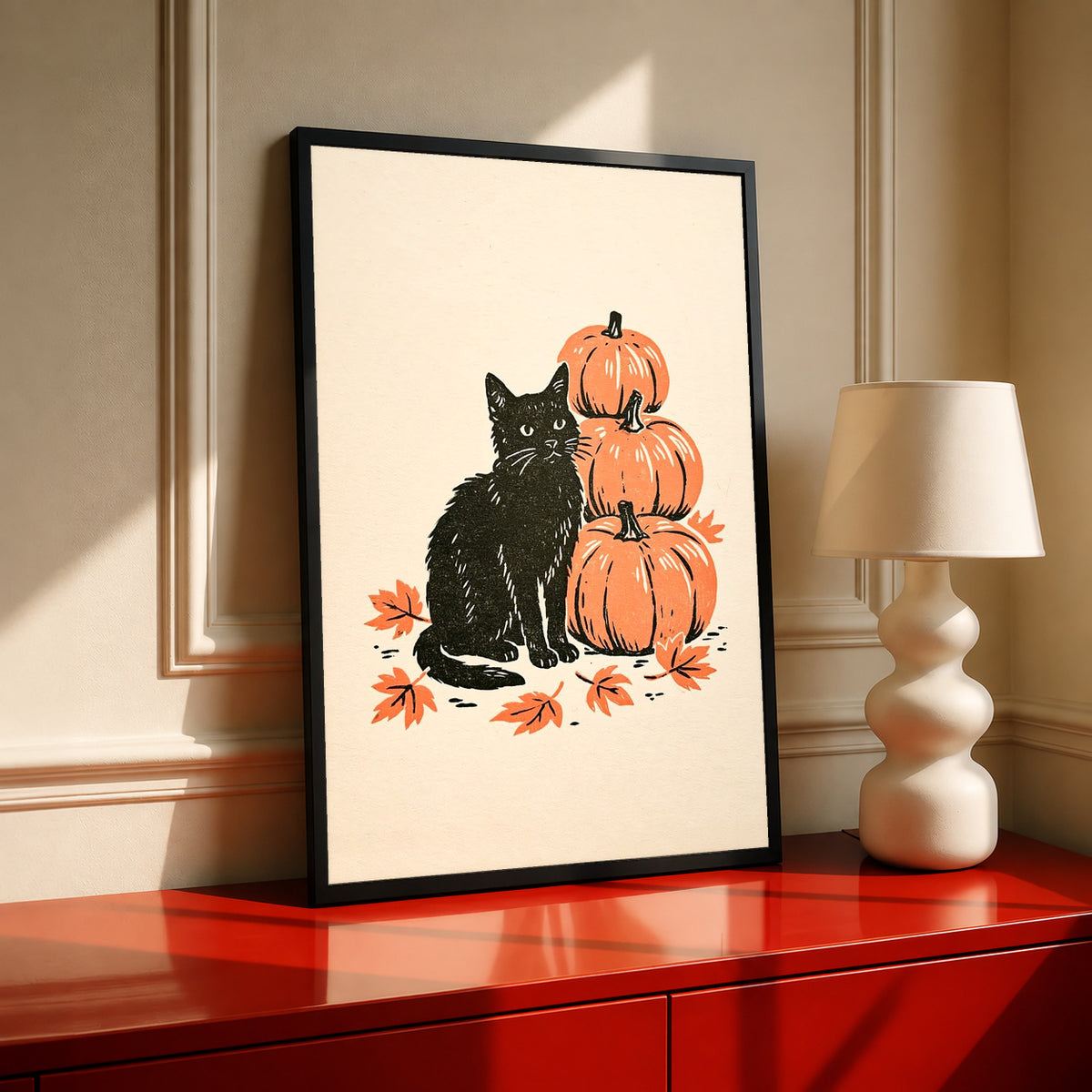 Black-framed autumn linocut art print of black cat with stacked orange pumpkins