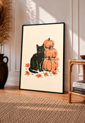 Framed autumn linocut art print: black cat with stacked orange pumpkins and leaves