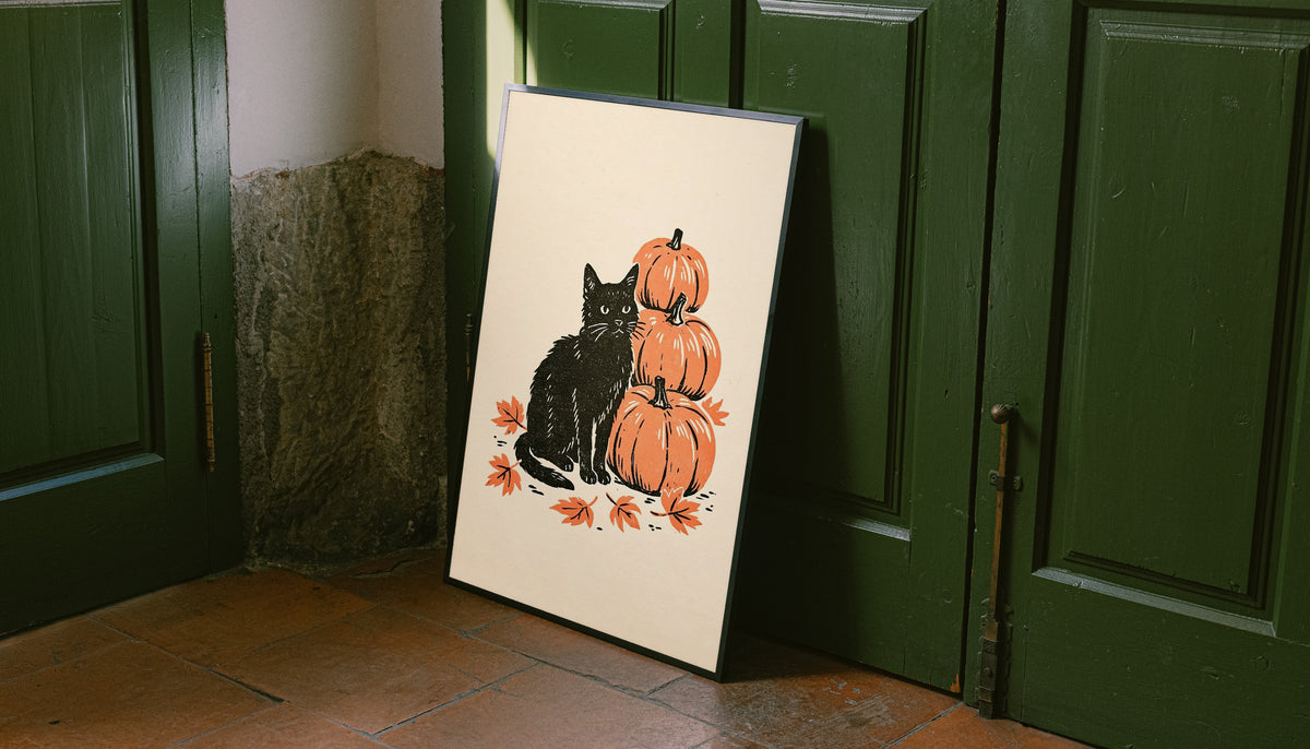Autumn linocut art print of black cat with stacked orange pumpkins and leaves