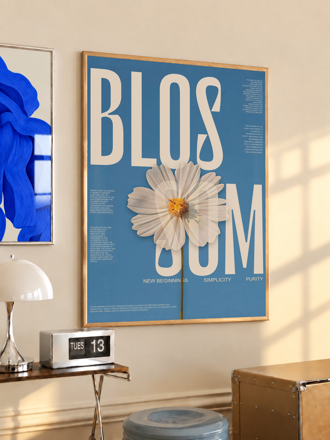 Blue framed wall poster with cream lettering and a white daisy flower illustration