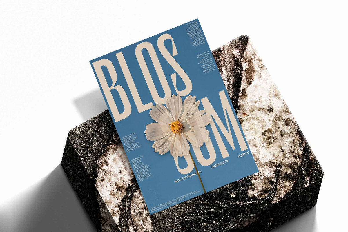 Blue poster with cream lettering and white daisy flower, displayed on a stone-like slab
