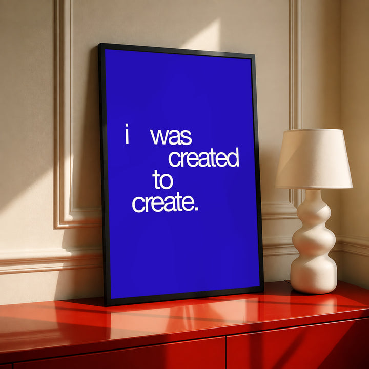Angled framed blue quote typography poster with white text: “I was created to create.”