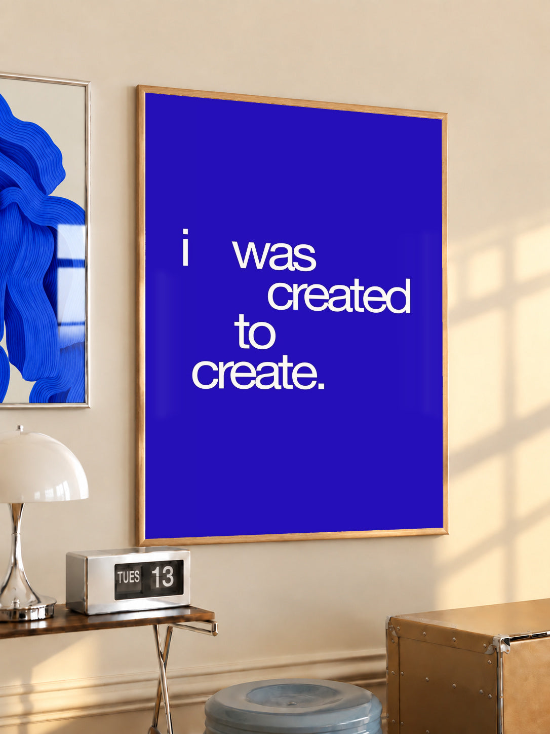 Framed blue quote typography poster with white text: “I was created to create.”