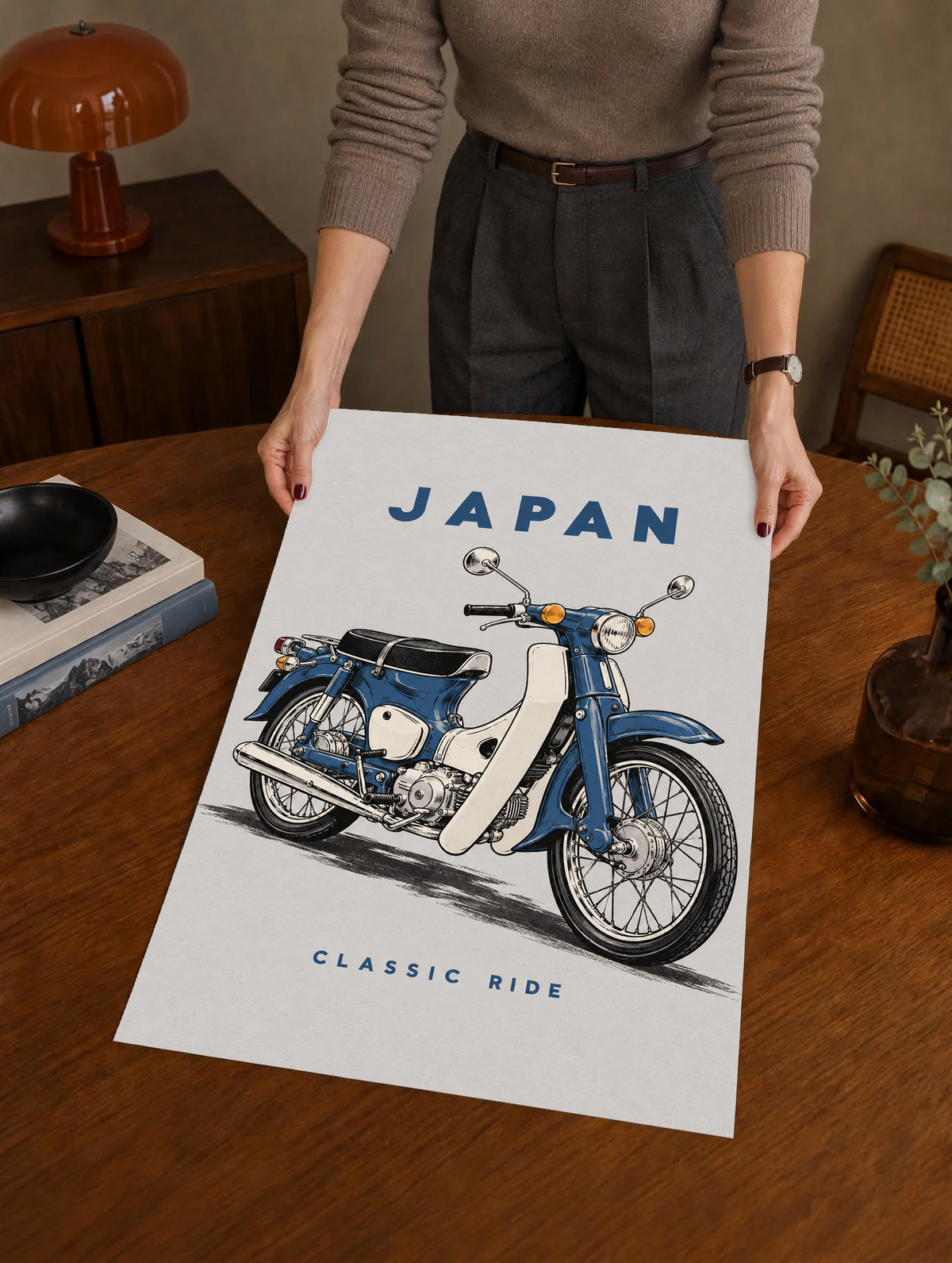 Japan motorcycle poster held up, showing a blue step-through bike and 'CLASSIC RIDE'.